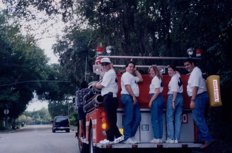 Crew and guests riding on the back of a fire truck – Corporate Events in Orlando, FL