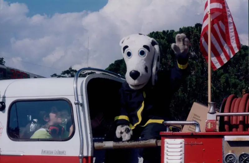 Dalmatian mascot waving from a fire truck – Grand Openings in Orlando, FL