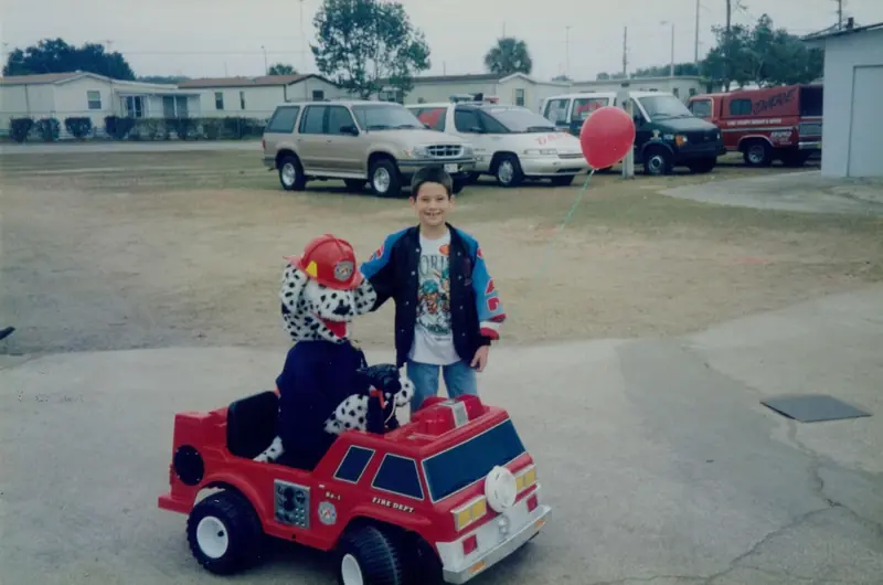 Child with a Dalmatian mascot and a toy fire truck at a school carnival – 1st Due Fire Truck Party and Events, Apopka FL
