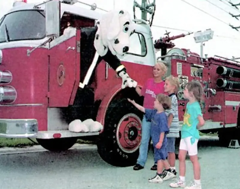 Kids meeting a Dalmatian mascot beside a classic red fire engine – 1st Due Fire Truck Party and Events