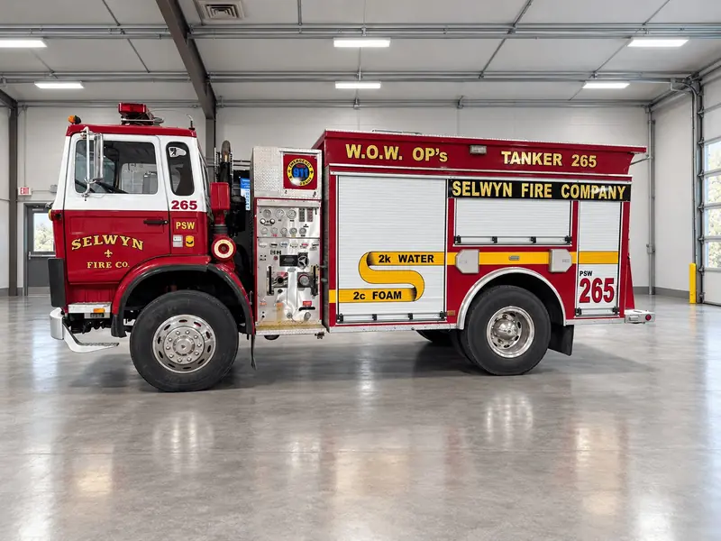 Driver side of red fire tanker 265 Water on Wheels with pump panel – 1st Due fire truck fleet
